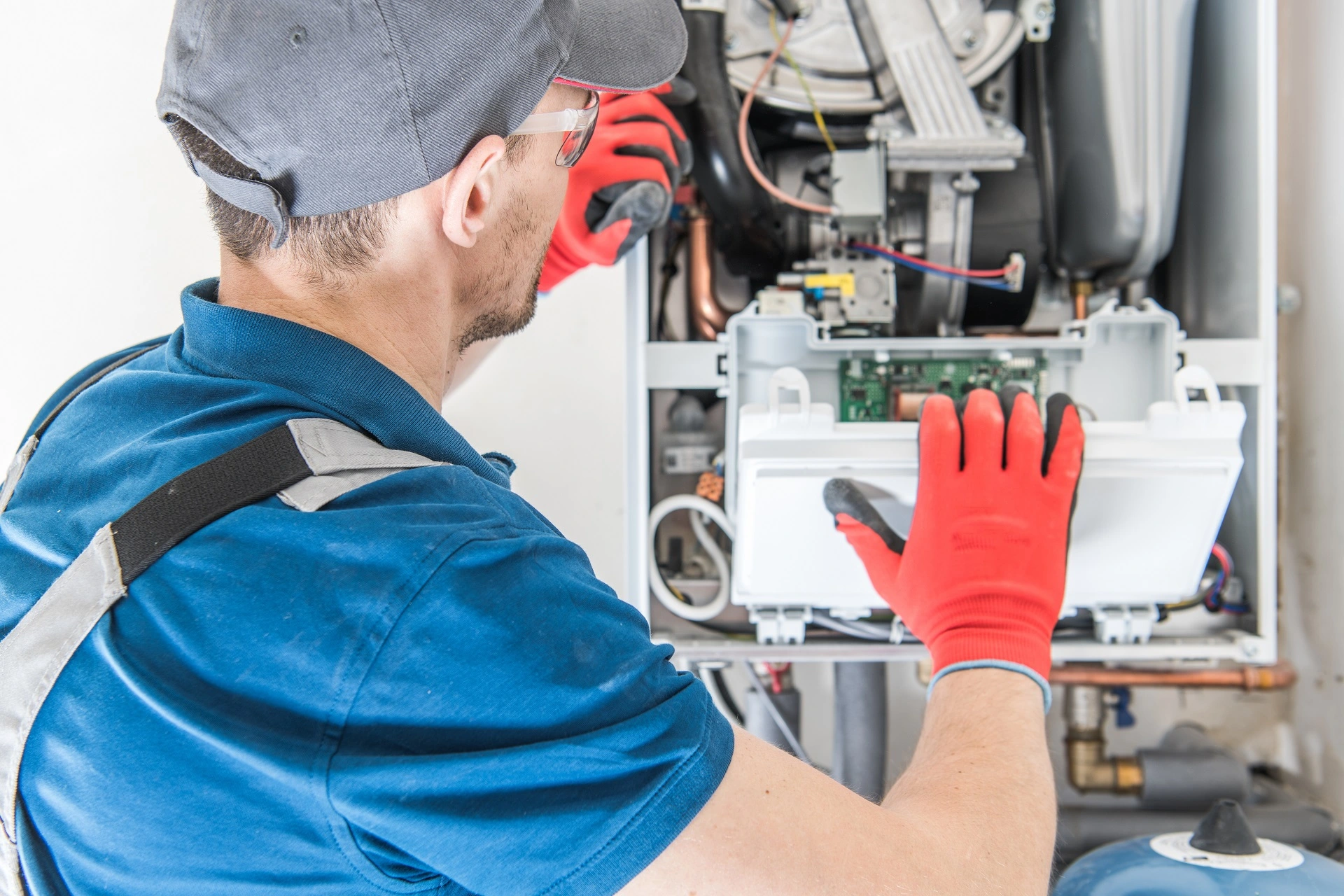 1st Choice Pro Services technician servicing a furnace in Parker, CO